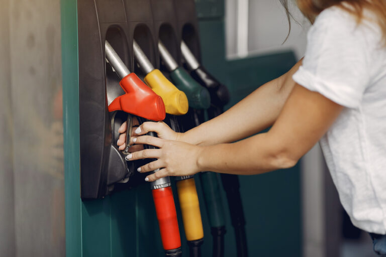 Elegant woman standing on a gas station