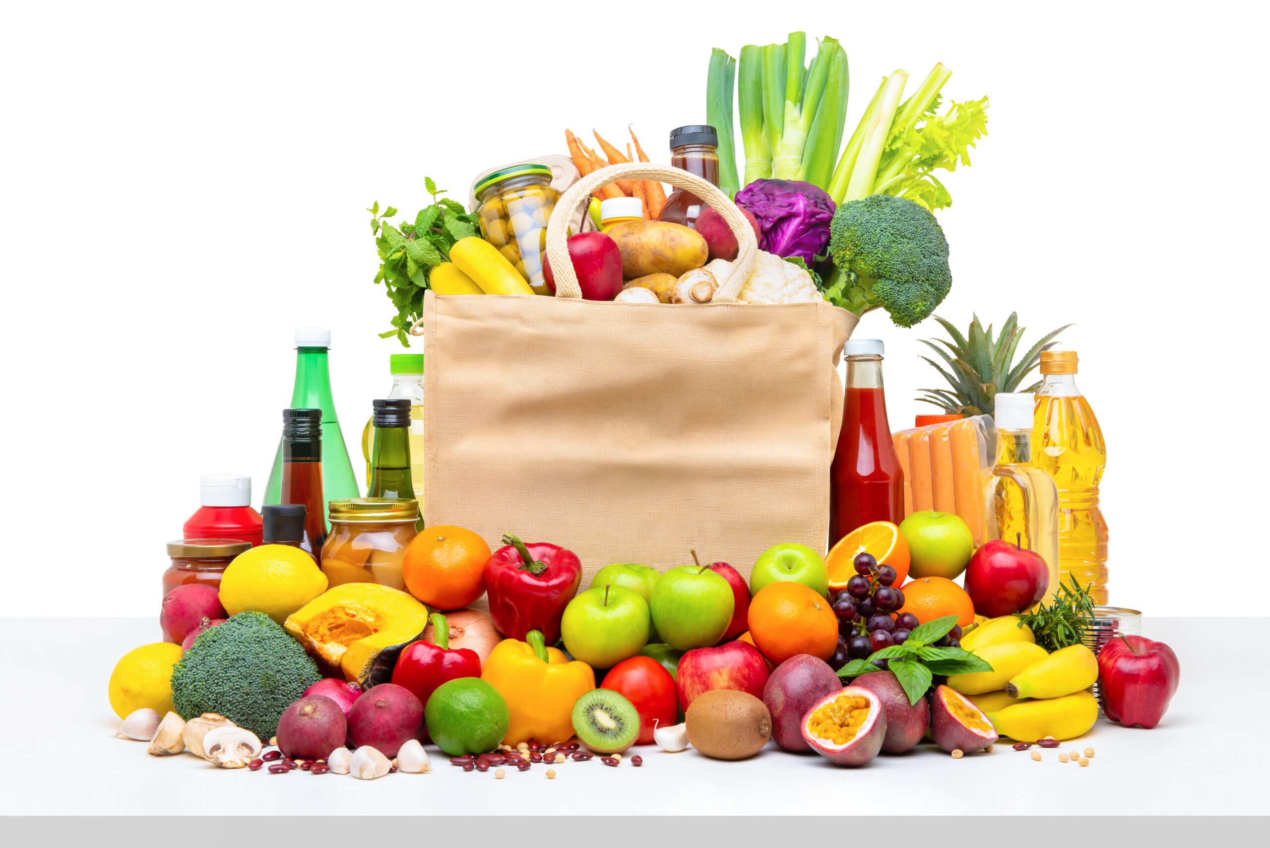 Shopping bag full of fresh fruits and vegetables with assorted i