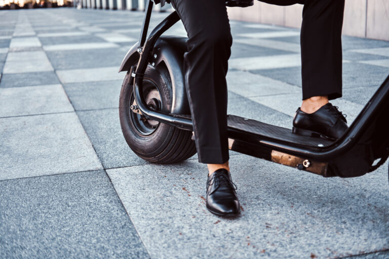 Man is driving his new electro scooter