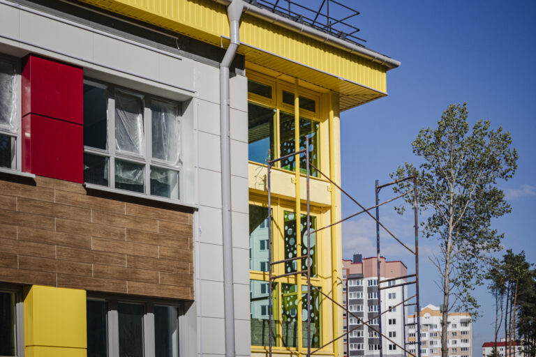 Scaffolding and scaffolding with wooden decks, against a blue sky. Performing construction work at height. Construction safety.