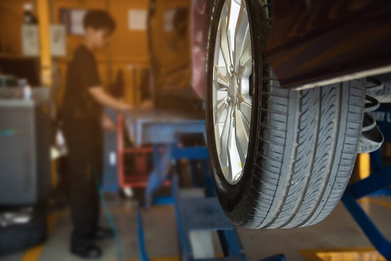 Technician is inflate car tire car maintenance service transportation safety