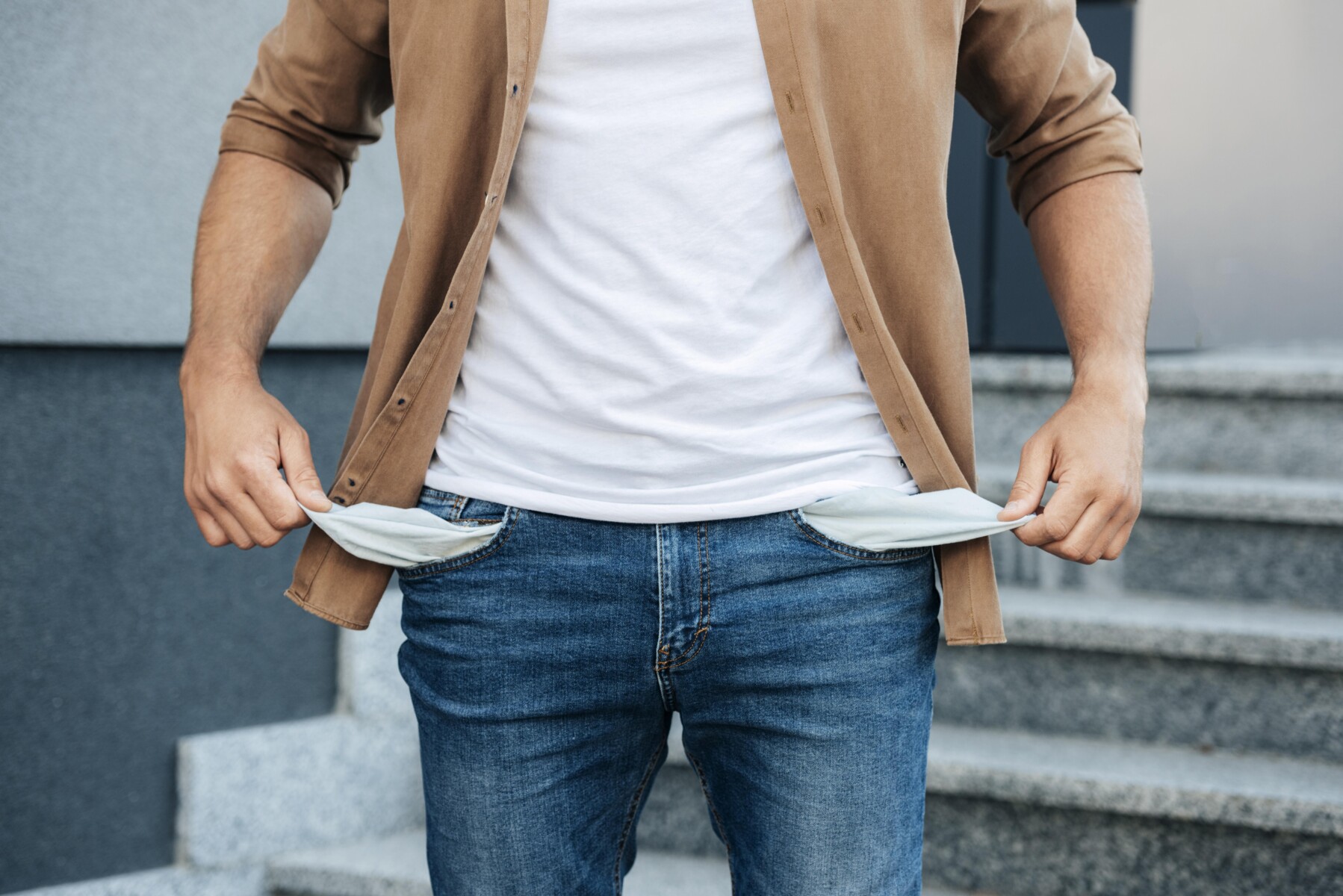 close-up-hands-pulling-out-jeans-pockets