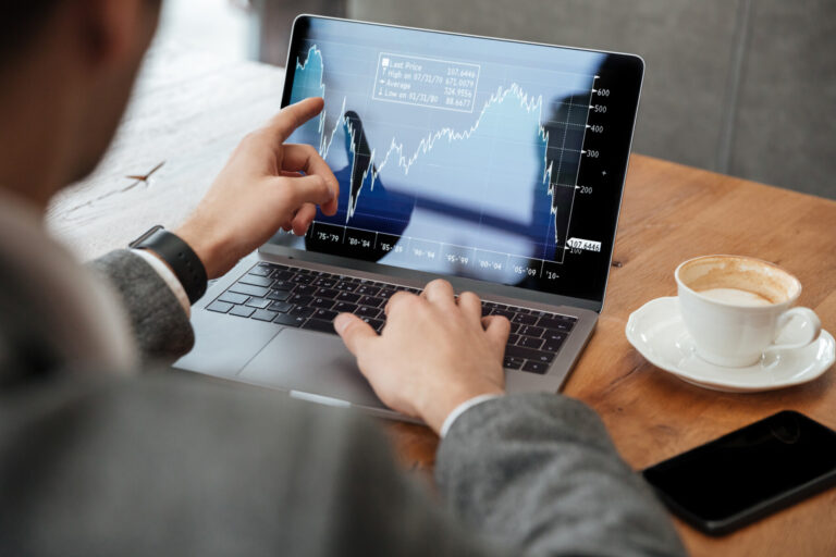 Cropped image of business man sitting by table in cafe