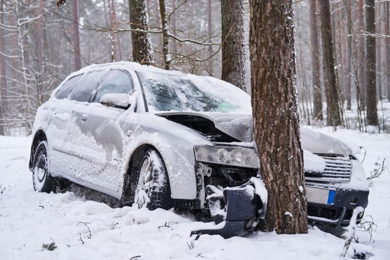 Broken car crashes into tree after losing control slippery road snowy forest abandoned car after accident