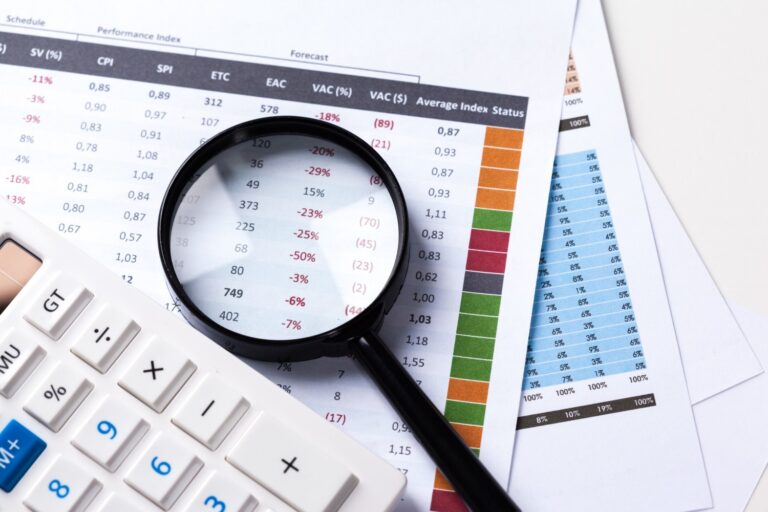 Work with magnifying glass calculator papers