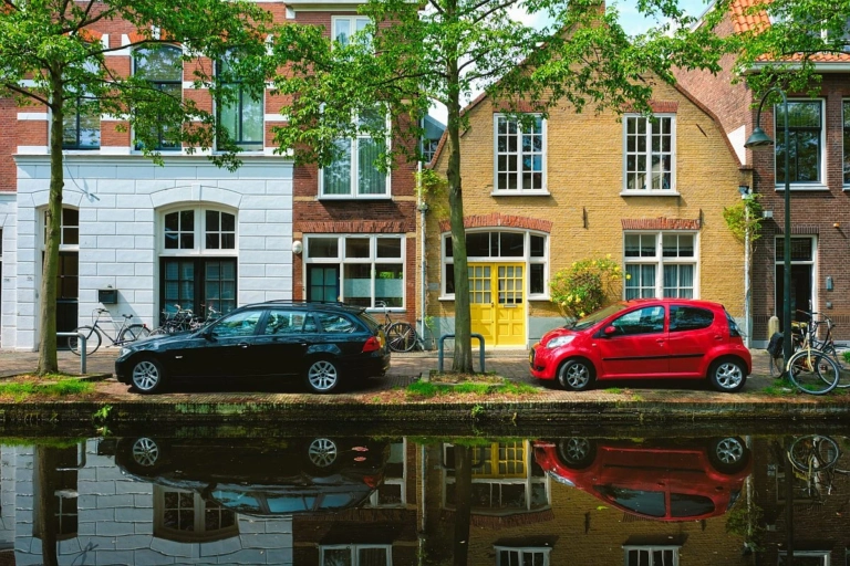 Cars canal embankment street delft delft netherlands