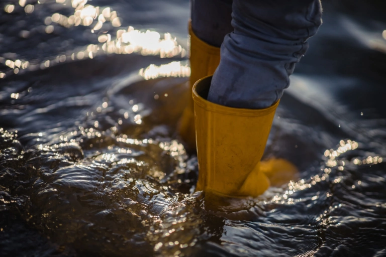 Person Blue Denim Jeans Yellow Boots Standing Water