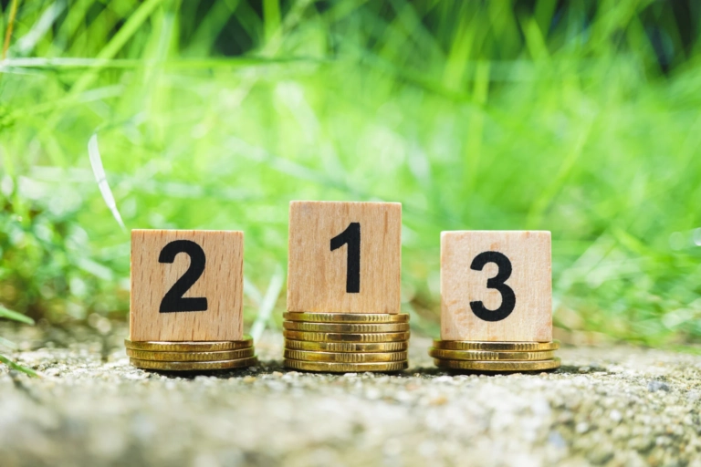 Wooden Number Golden Stack Coins With Green Nature Background