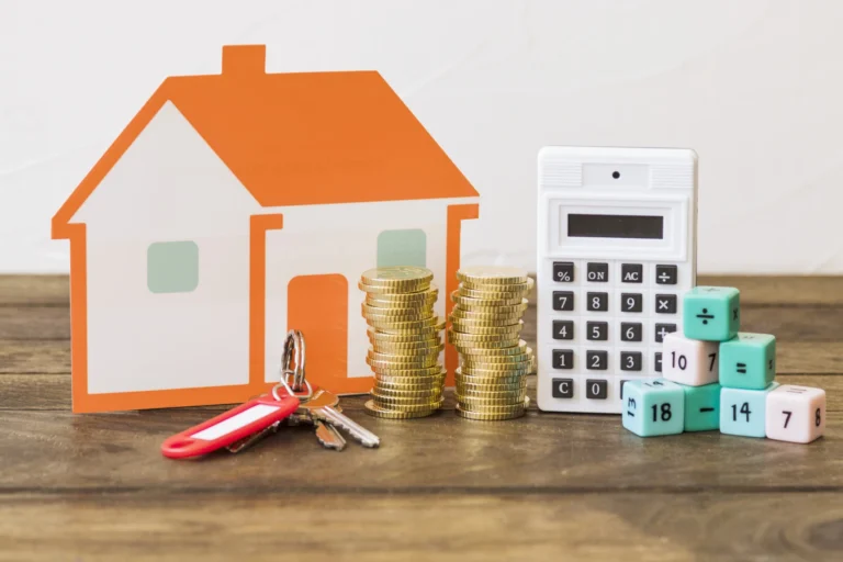 House key stacked coins calculator math blocks wooden table