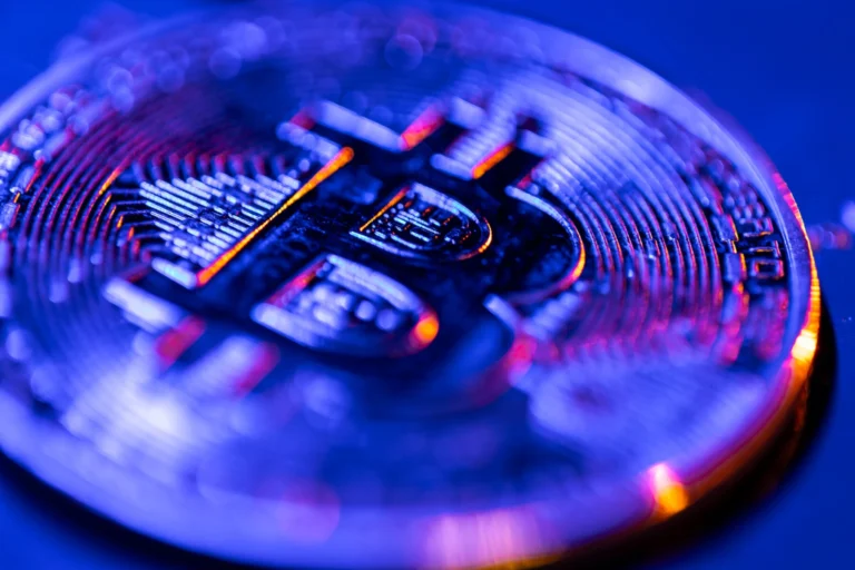 Bitcoin coin closeup blue color finance concept