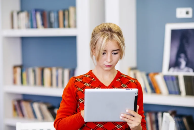 Young woman using tablet library