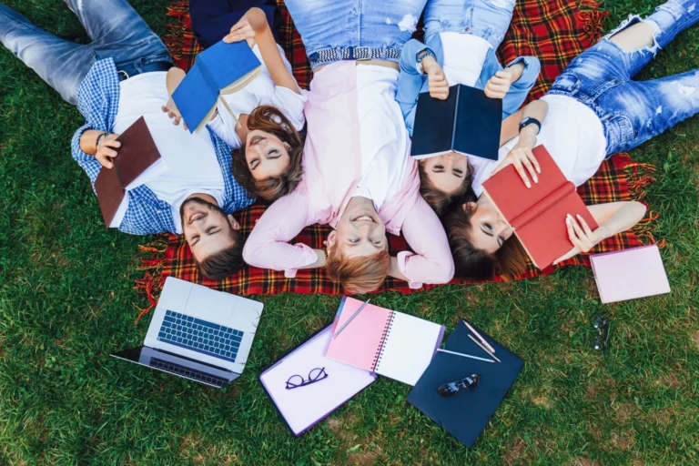 Group young beautiful people lie grass students relax after classes campus