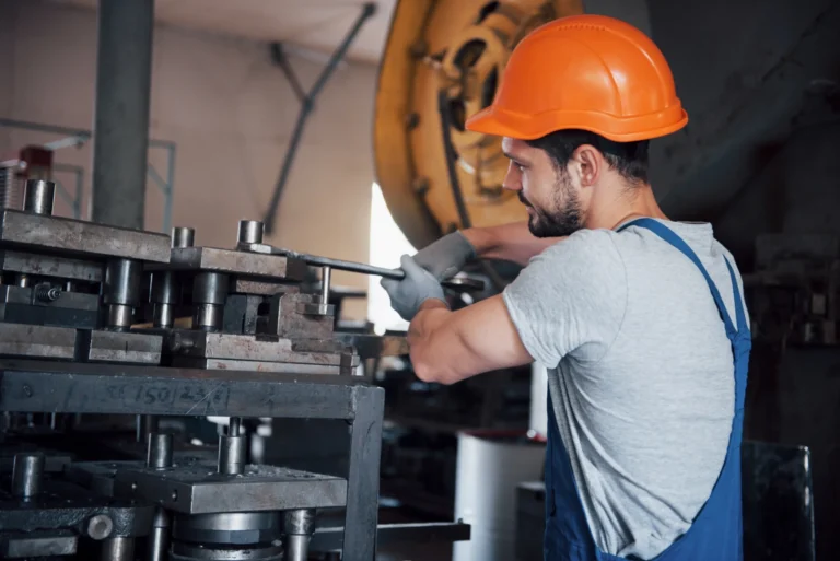 Portrait young worker hard hat large metalworking plant