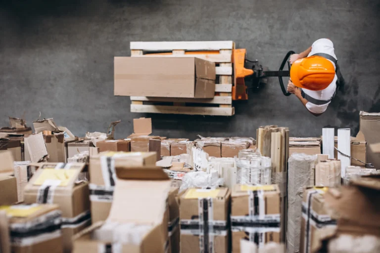 Young man working warehouse with boxes