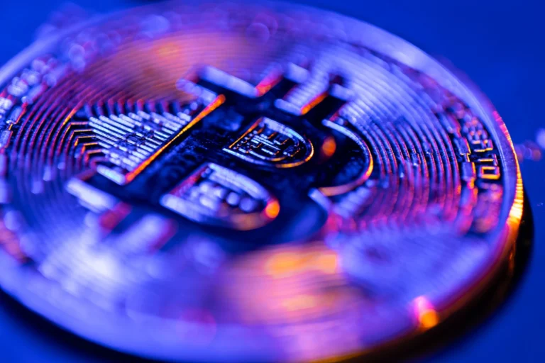 Bitcoin coin closeup blue color finance concept